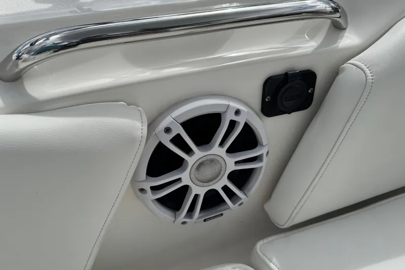 Slide: The Image of 2024 Key West 263 FS boat interior with speaker and white upholstery. - 56