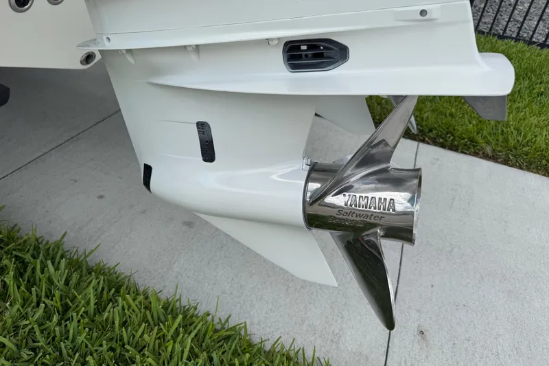 Slide: The Image of 2024 Key West 263 FS boat with Yamaha saltwater propeller on concrete and grass. - 6