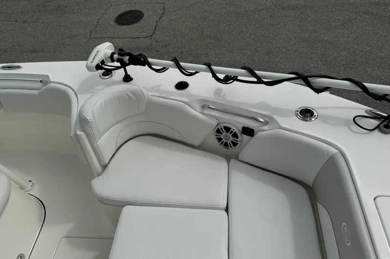 Slide: The Image of 2024 Key West 263 FS boat interior with white seating and Garmin equipment. - 61