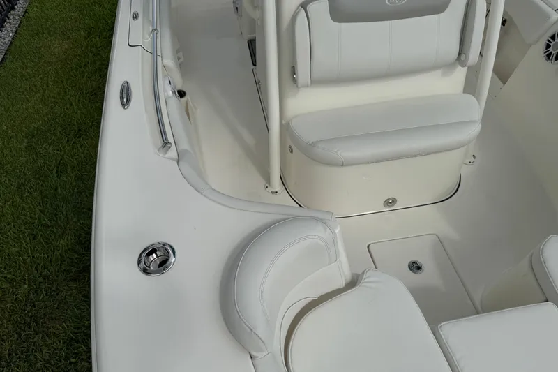 Slide: The Image of 2024 Key West 263 FS boat interior with white seating and deck details. - 64