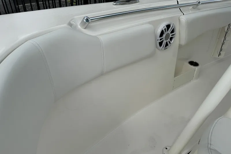 Slide: The Image of 2024 Key West 263 FS boat interior with white seating and speaker detail. - 74