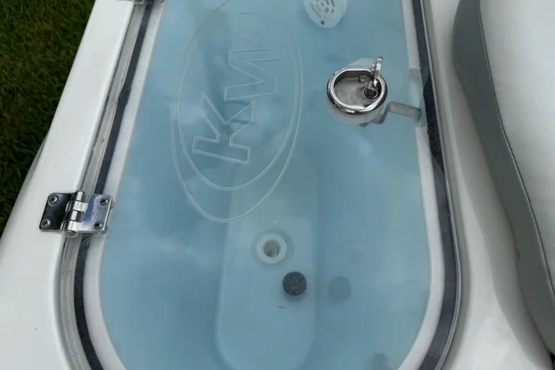 Slide: The Image of 2024 Key West 263 FS boat livewell with KW logo and latch. - 77