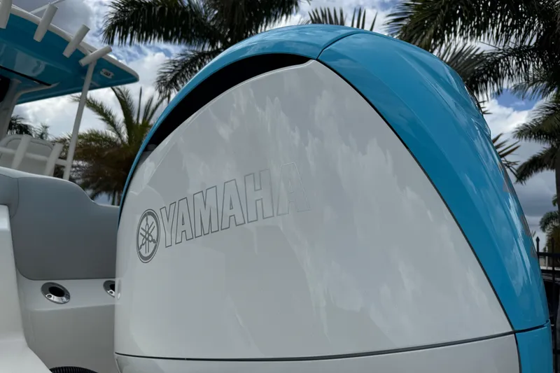 Slide: The Image of 2024 Key West 263 FS boat with Yamaha engine, palm trees in background. - 8