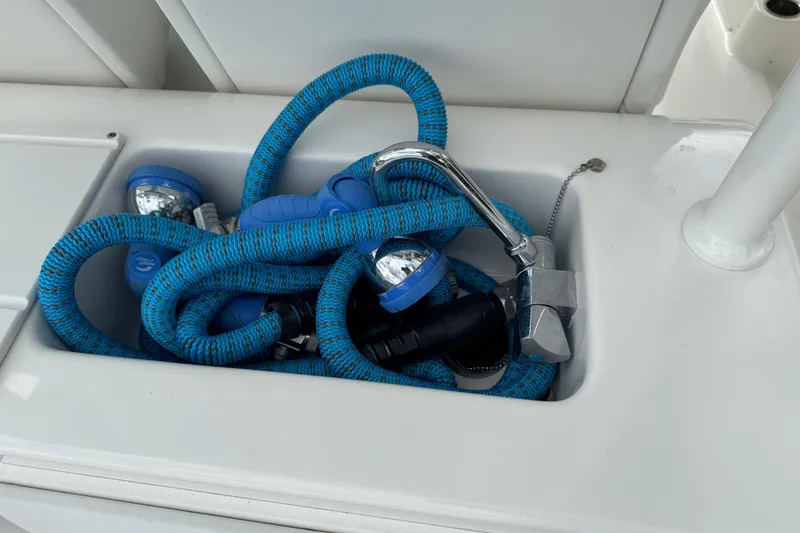 Slide: The Image of Coiled blue hose and faucet on 2024 Key West 263 FS boat deck. - 80