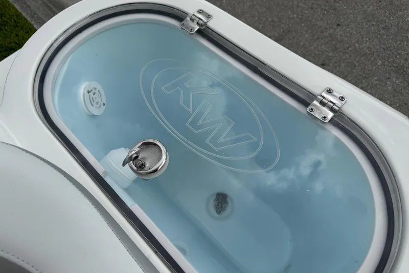 Slide: The Image of Livewell on 2024 Key West 263 FS boat, featuring KW logo and secure latch. - 83
