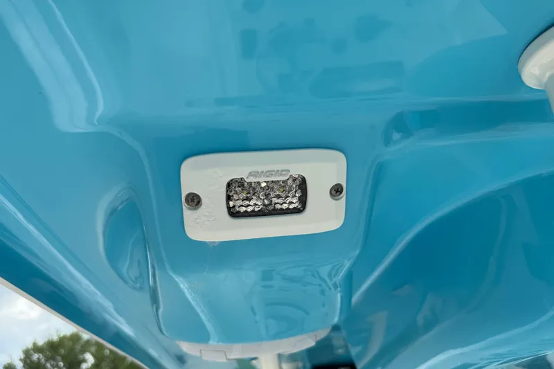 Slide: The Image of Close-up of a 2024 Key West 263 FS boat's blue hull with a mounted light. - 84