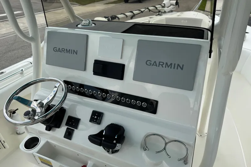 Slide: The Image of 2024 Key West 263 FS boat dashboard with Garmin displays and steering wheel. - 91