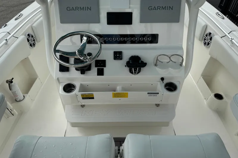 Slide: The Image of 2024 Key West 263 FS boat dashboard with Garmin displays and steering wheel. - 93