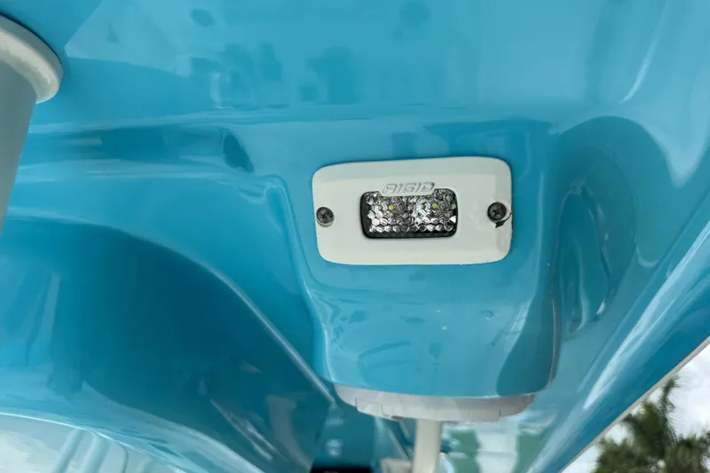 Slide: The Image of 2024 Key West 263 FS boat detail with blue hull and mounted light. - 94