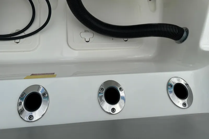 Slide: The Image of 2024 Key West 263 FS boat drainage system with chrome fittings and black hose. - 97