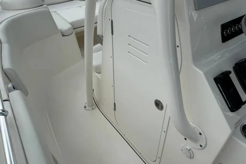Slide: The Image of 2024 Key West 263 FS boat interior, featuring sleek white seating and control panel. - 98