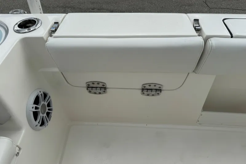 Slide: The Image of 2024 Key West 263 FS boat interior with white seating and speaker. - 99