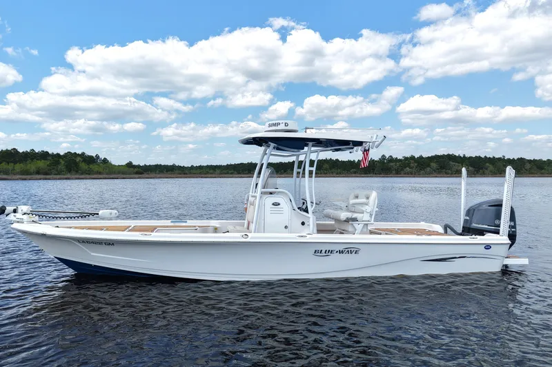 The Image of 2021 Blue Wave 2600 PureBay boat on calm water under a partly cloudy sky. - 0