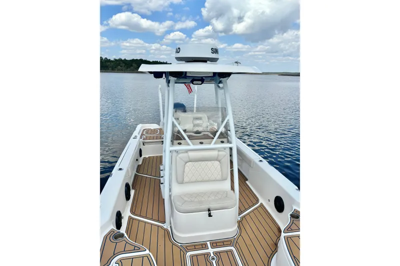 Slide: The Image of 2021 Blue Wave 2600 PureBay boat on calm water under a cloudy sky. - 17