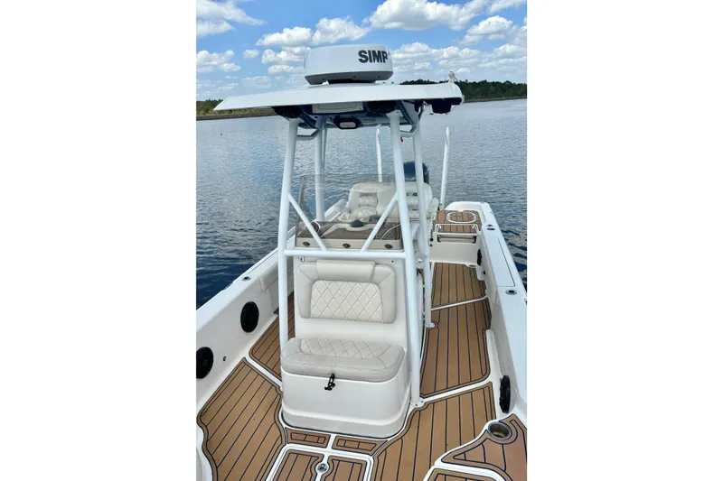 Slide: The Image of 2021 Blue Wave 2600 PureBay boat with sleek design on calm water. - 19