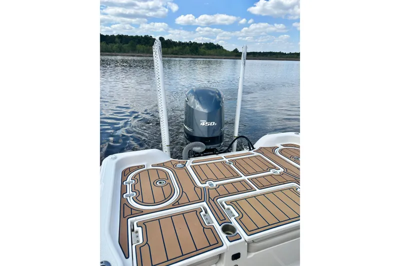 Slide: The Image of 2021 Blue Wave 2600 PureBay boat with 450 horsepower engine on a serene lake. - 20