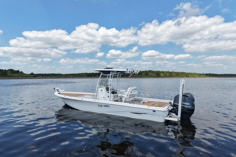 Slide: The Image of 2021 Blue Wave 2600 PureBay boat on calm lake under blue sky with clouds. - 3