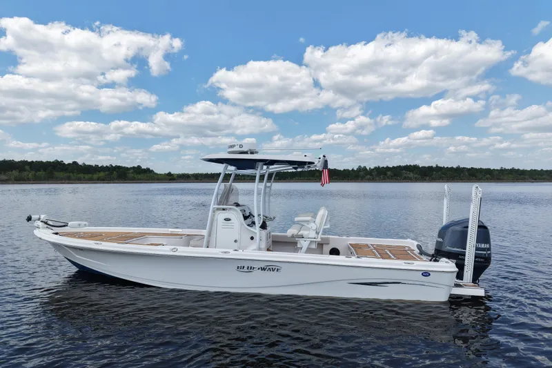 Slide: The Image of 2021 Blue Wave 2600 PureBay boat on calm water under a blue sky. - 5