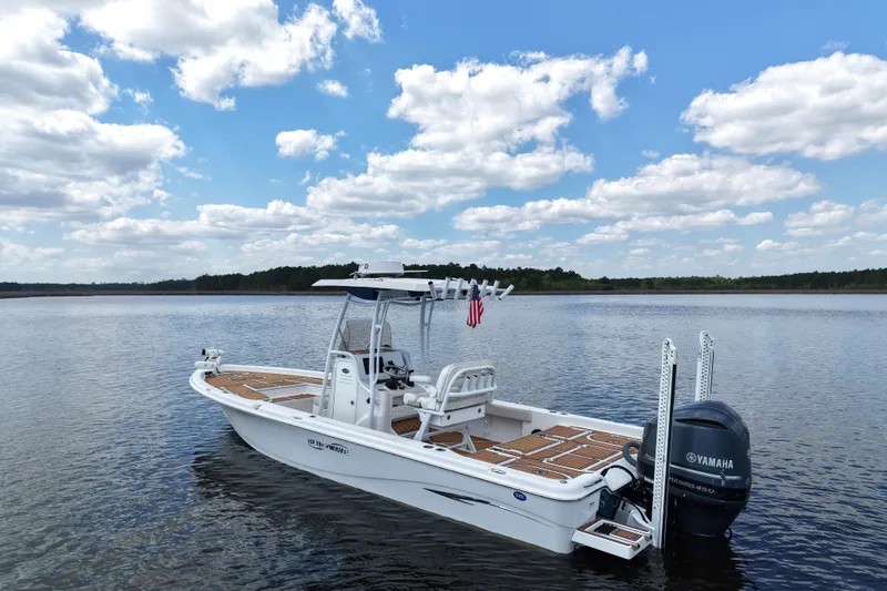 Slide: The Image of 2021 Blue Wave 2600 PureBay boat on calm lake under blue sky. - 7