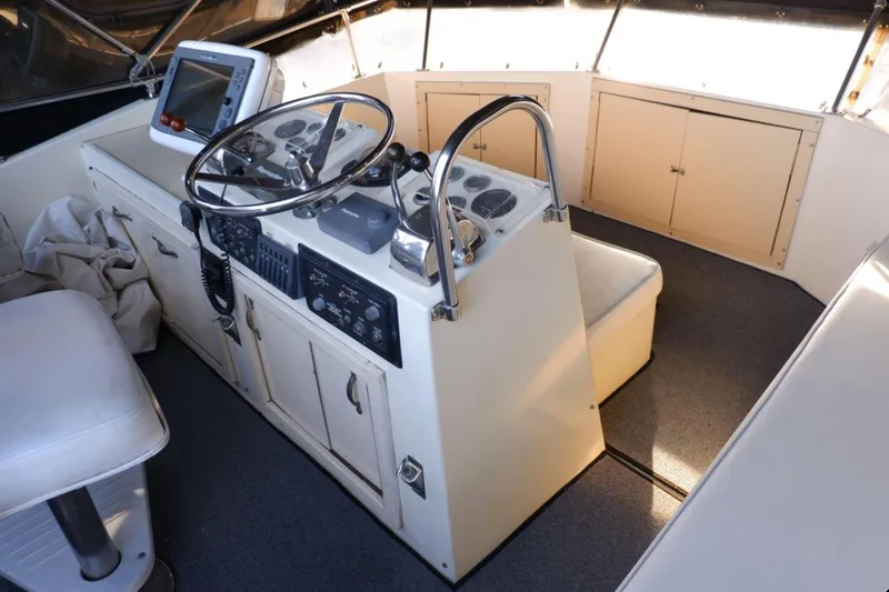 Slide: The Image of 1978 Hatteras 45 Express Sportfish helm with steering wheel and navigation equipment. - 12