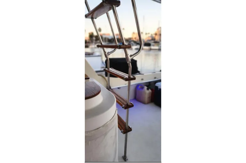 Slide: The Image of Staircase on 1978 Hatteras 45 Express Sportfish boat, docked at marina. - 24