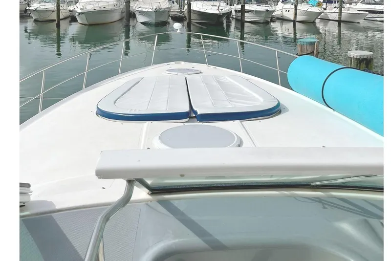 Slide: The Image of 2005 Cruisers Yachts 440 Express docked in a marina with city skyline. - 10