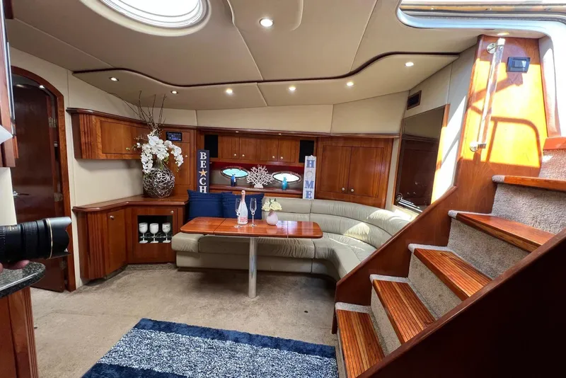 Slide: The Image of Luxurious 2005 Cruisers Yachts 440 Express interior with elegant wood finishes and cozy seating. - 12