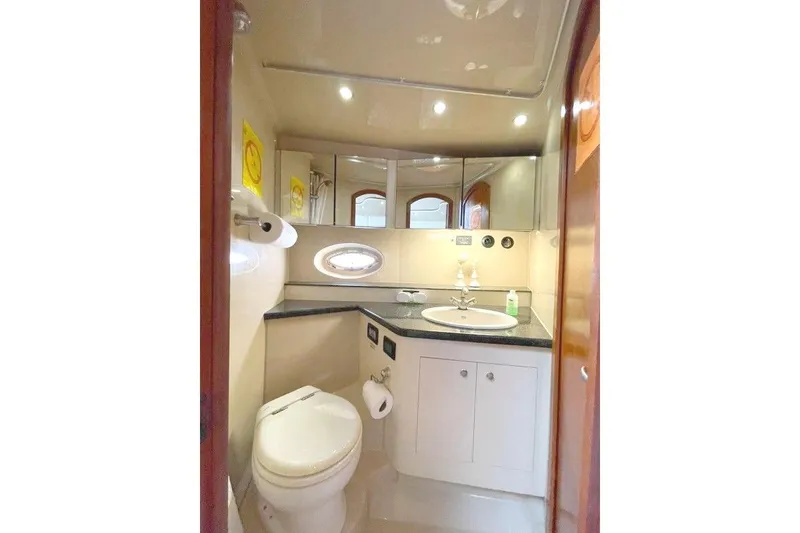 Slide: The Image of Luxurious bathroom in 2005 Cruisers Yachts 440 Express with modern fixtures and elegant design. - 13