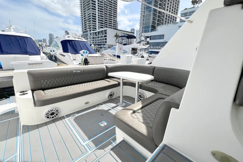 Slide: The Image of Luxurious seating area on a 2005 Cruisers Yachts 440 Express, docked at a marina. - 16
