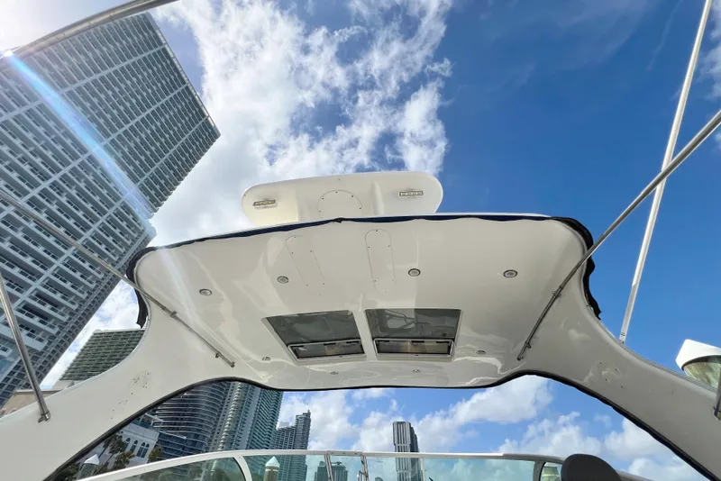 Slide: The Image of 2005 Cruisers Yachts 440 Express boat roof with city skyline and blue sky. - 21
