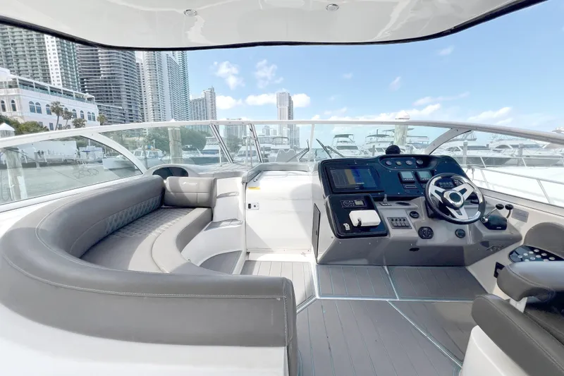 Slide: The Image of Luxurious 2005 Cruisers Yachts 440 Express helm with city skyline and marina view. - 26