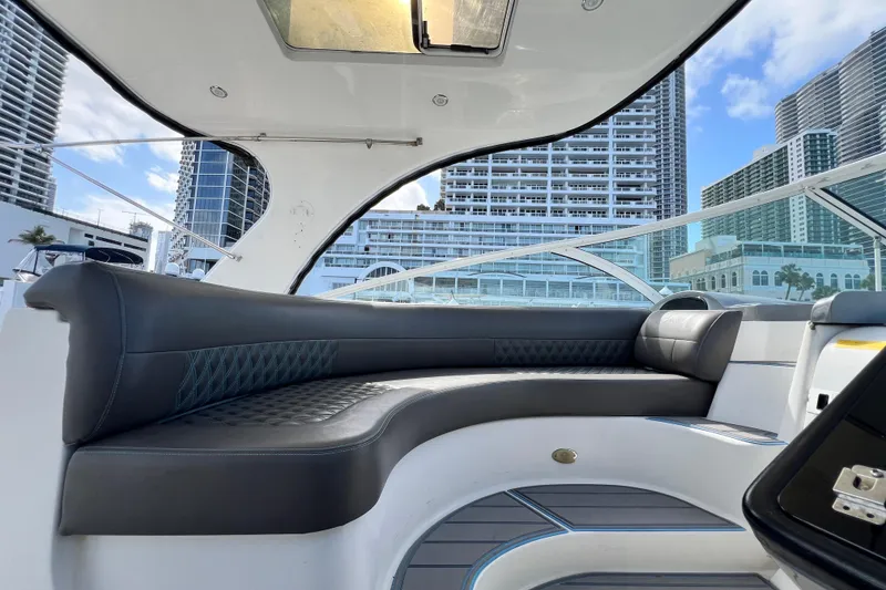 Slide: The Image of Luxurious seating area on a 2005 Cruisers Yachts 440 Express with cityscape backdrop. - 27
