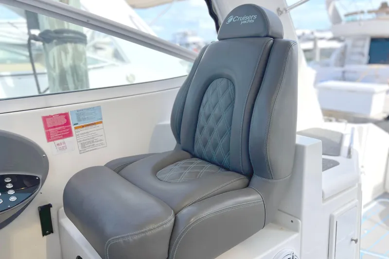 Slide: The Image of Captain's seat on 2005 Cruisers Yachts 440 Express, featuring luxurious black leather upholstery. - 31