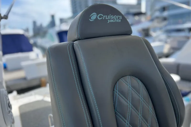 Slide: The Image of Luxury seating on a 2005 Cruisers Yachts 440 Express, featuring elegant stitching. - 32