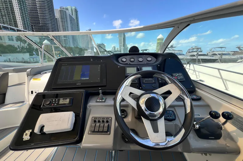 Slide: The Image of Helm of 2005 Cruisers Yachts 440 Express with modern navigation equipment and city skyline view. - 33