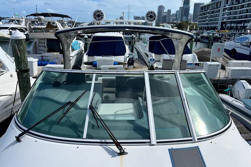 Slide: The Image of 2005 Cruisers Yachts 440 Express docked at marina, surrounded by other boats. - 37