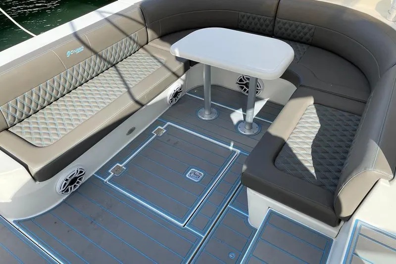 Slide: The Image of 2005 Cruisers Yachts 440 Express interior with cushioned seating and table. - 4