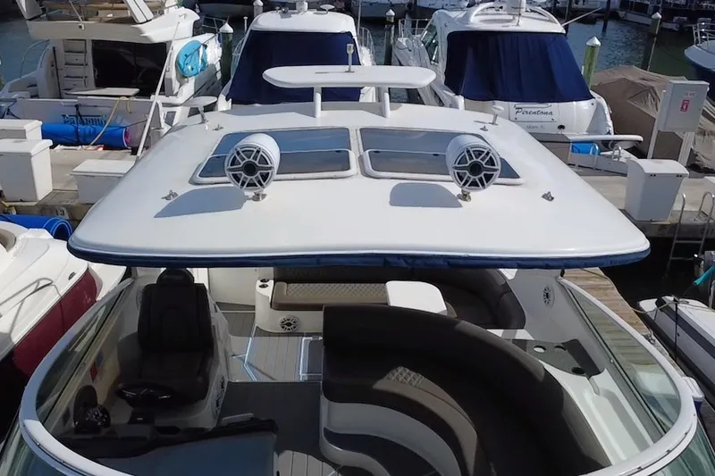 Slide: The Image of 2005 Cruisers Yachts 440 Express docked, featuring spacious deck and modern design. - 40