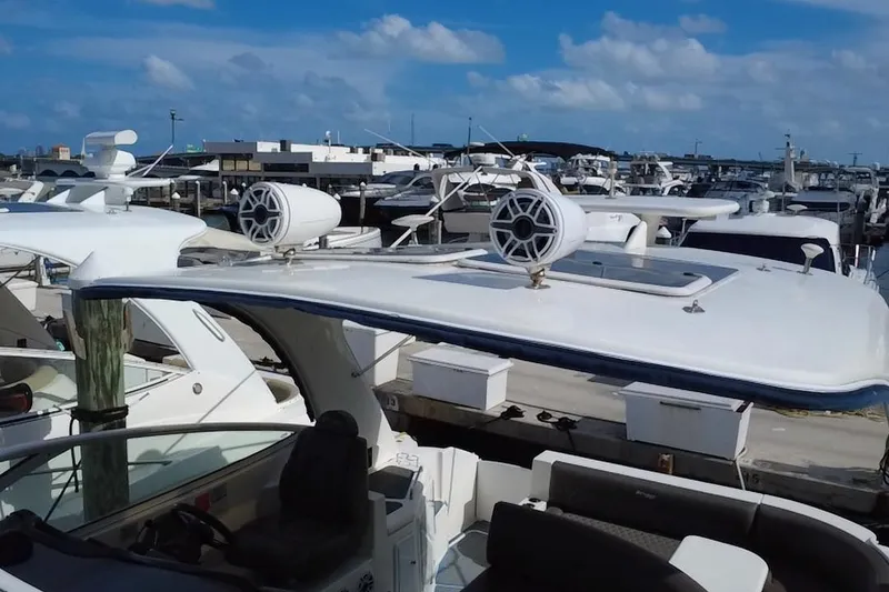 Slide: The Image of 2005 Cruisers Yachts 440 Express docked at marina under blue sky. - 41