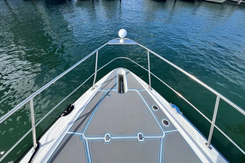 Slide: The Image of Bow view of 2005 Cruisers Yachts 440 Express on calm water. - 42