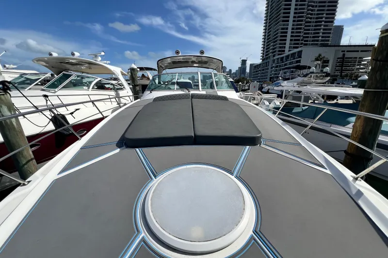 Slide: The Image of 2005 Cruisers Yachts 440 Express docked at marina, sunny day, city skyline background. - 45