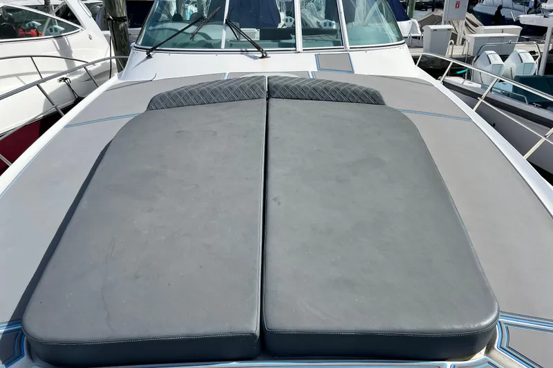 Slide: The Image of 2005 Cruisers Yachts 440 Express with cushioned deck, docked at marina. - 46