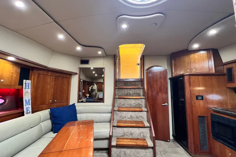 Slide: The Image of Luxurious interior of 2005 Cruisers Yachts 440 Express with elegant wood finishes and cozy seating. - 47