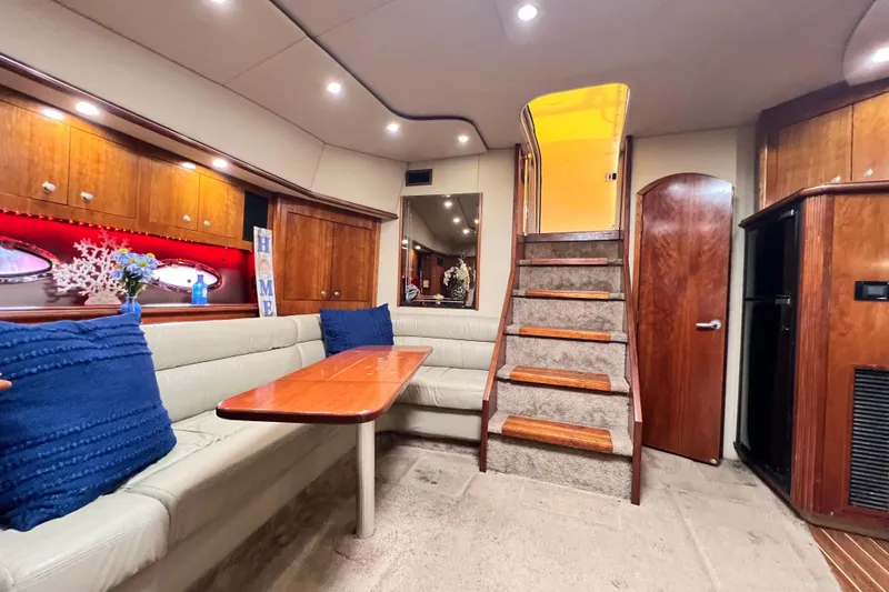 Slide: The Image of Luxurious 2005 Cruisers Yachts 440 Express interior with elegant seating and wooden accents. - 56