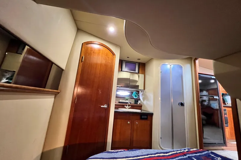 Slide: The Image of Interior of 2005 Cruisers Yachts 440 Express, featuring wood cabinetry and modern design elements. - 62