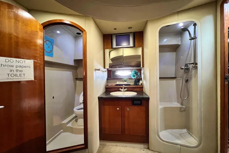 Slide: The Image of 2005 Cruisers Yachts 440 Express bathroom with shower, sink, and toilet. - 64