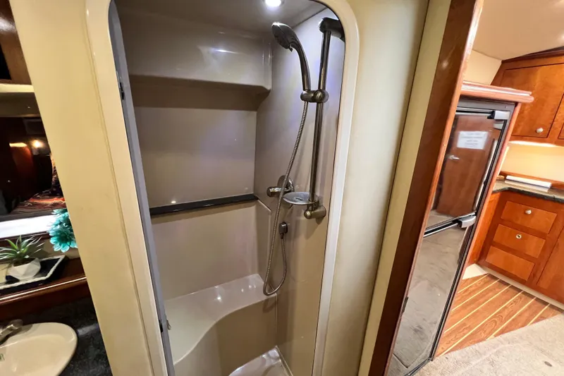 Slide: The Image of 2005 Cruisers Yachts 440 Express interior shower and kitchenette area. - 69