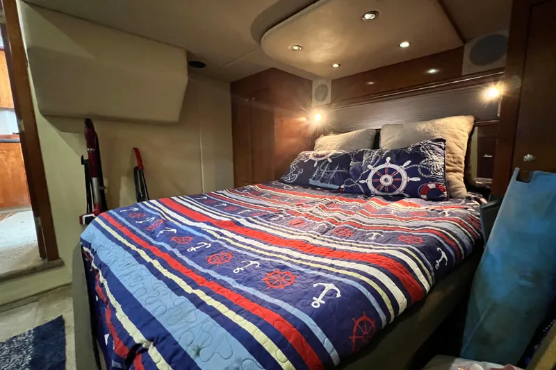 Slide: The Image of Luxurious 2005 Cruisers Yachts 440 Express cabin with nautical-themed bedding. - 70