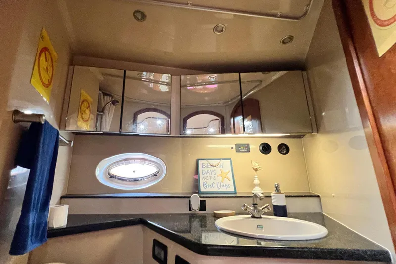 Slide: The Image of Luxurious bathroom interior of 2005 Cruisers Yachts 440 Express with modern fixtures and decor. - 72