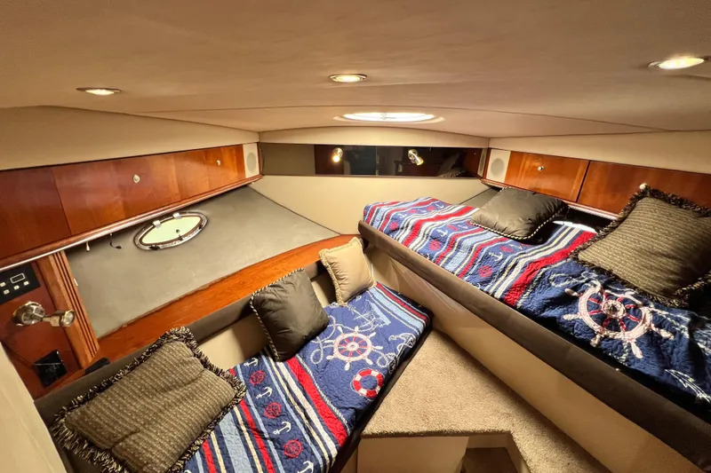 Slide: The Image of Interior cabin of 2005 Cruisers Yachts 440 Express with nautical-themed bedding. - 78